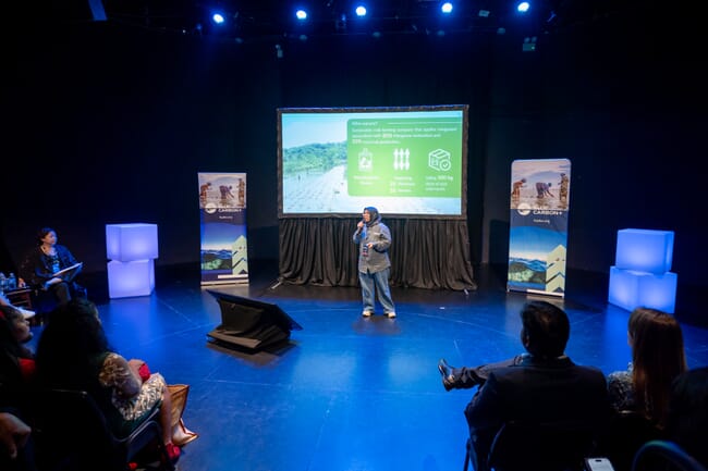 A person giving a presentation on a stage.