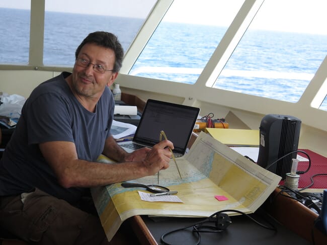 A man navigating using a chart.