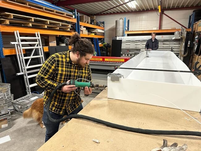 A man building a wastewater treatment tank.