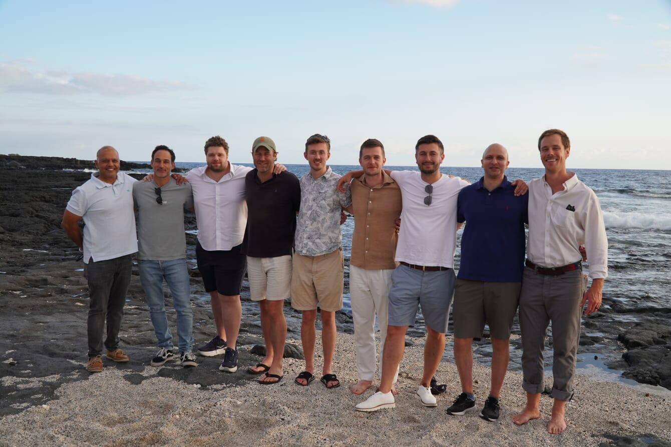 A group photo, on a beach.