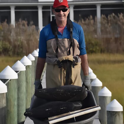 A man pushing a wheelbarrow