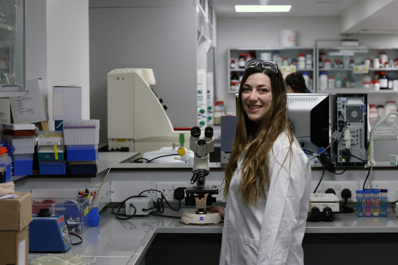 A person in a lab coat in a science laboratory.