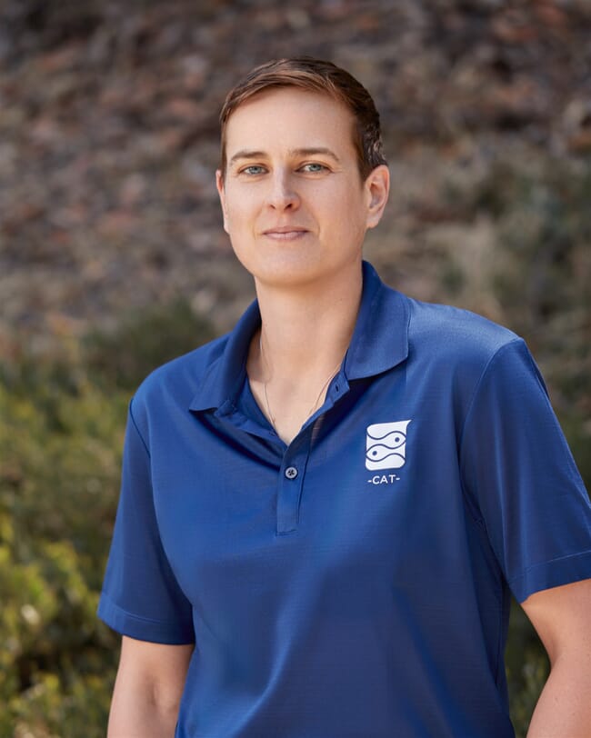 A woman wearing a blue polo shirt