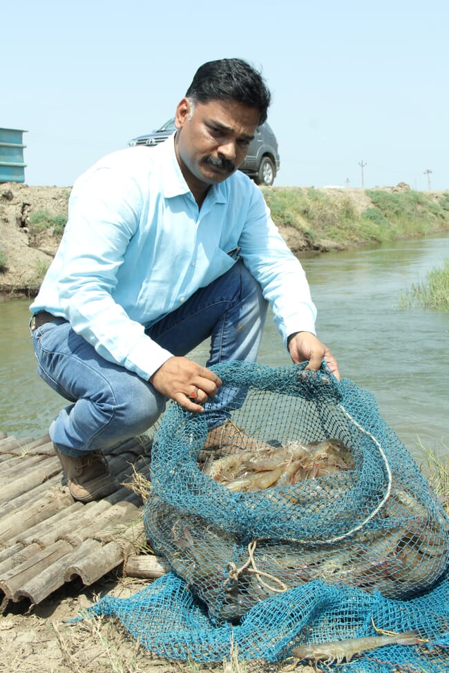 A man holding a shrimp basket.