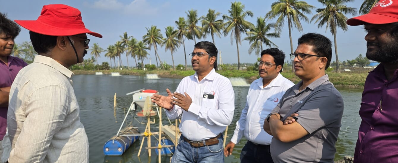 Men talking at a shrimp farm.
