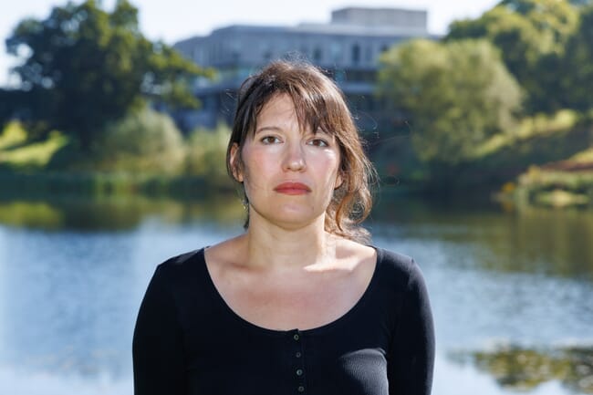 Woman standing in university gardens.