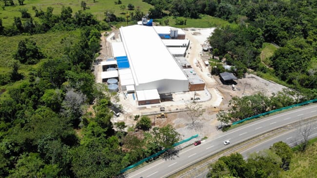 Aerial view of a large building in a forest.