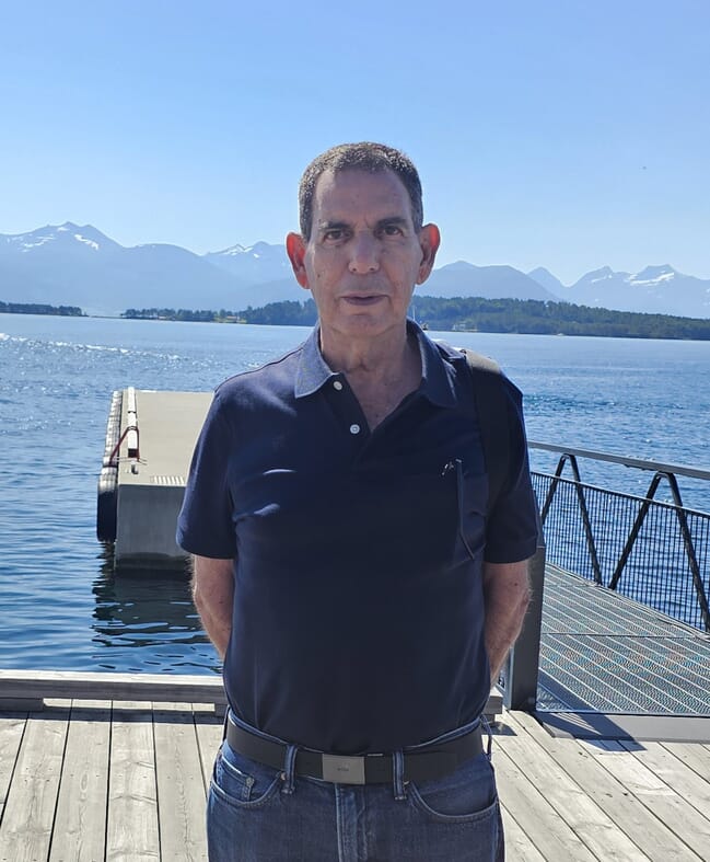 A man standing in front of the sea.