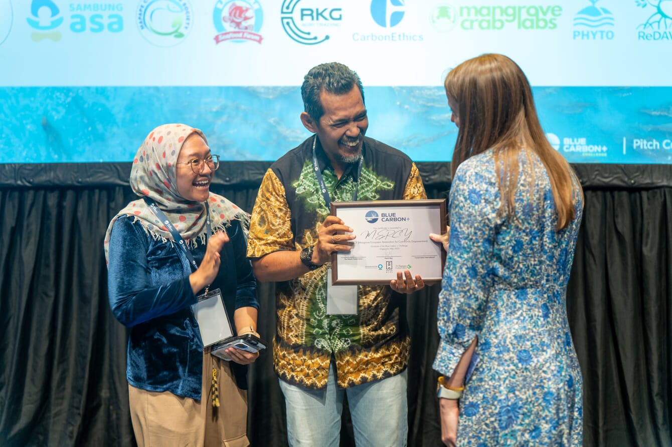 Two people collecting a prize.