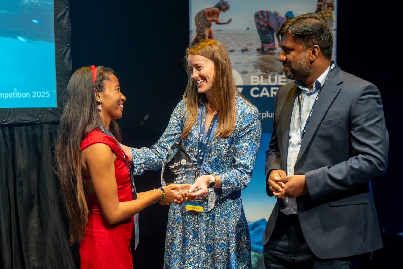 A woman collecting a prize on stage.