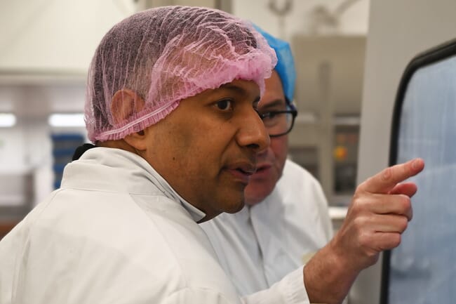 A man visiting a food processing facility.