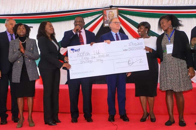 Angela Odero receiving cheque on stage