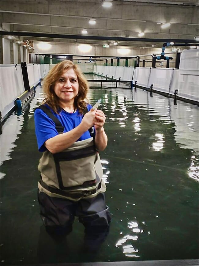 Janeth Chavez Zambrano in an indoor shrimp tank