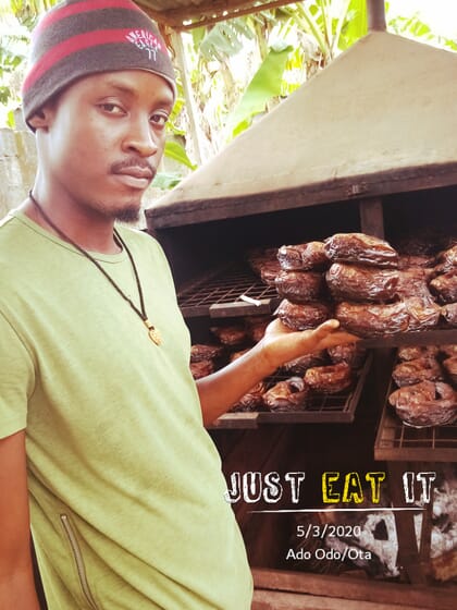 man standing with smoked catfish