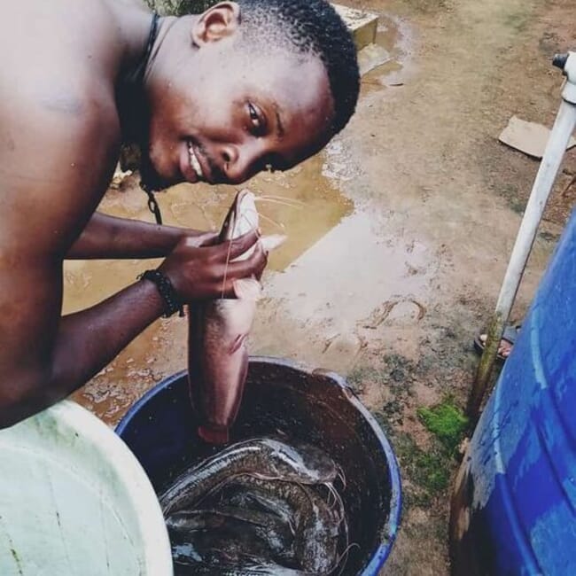 man holding a catfish