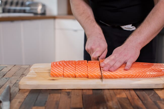 A person cutting fish.
