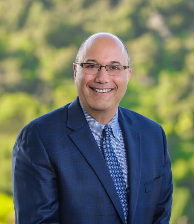 Lou Cooperhouse standing in front of BlueNalu's San Diego facility