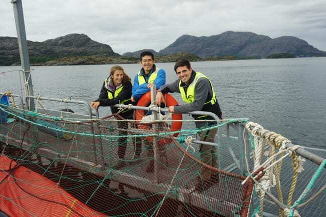 Three people on a fish farm.
