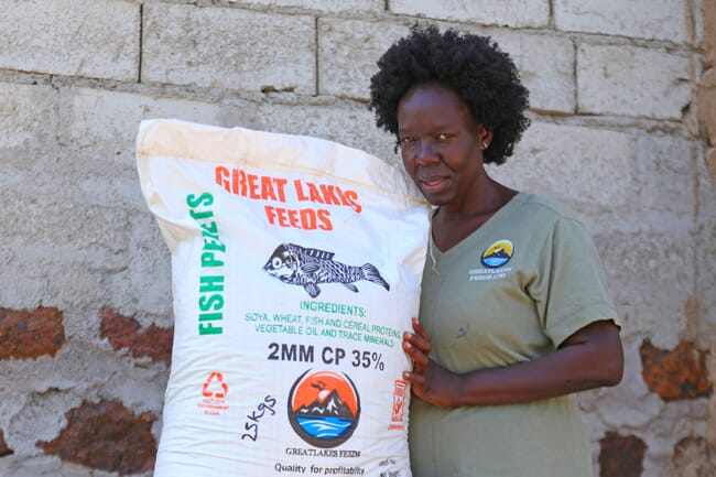 Woman with bag of fish feed