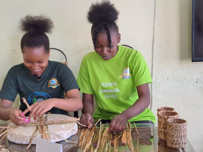 two women weaving baskets