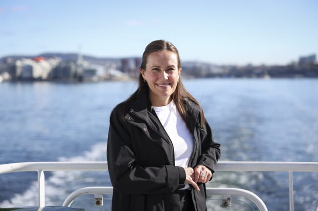 A woman standing on a fishing boat.