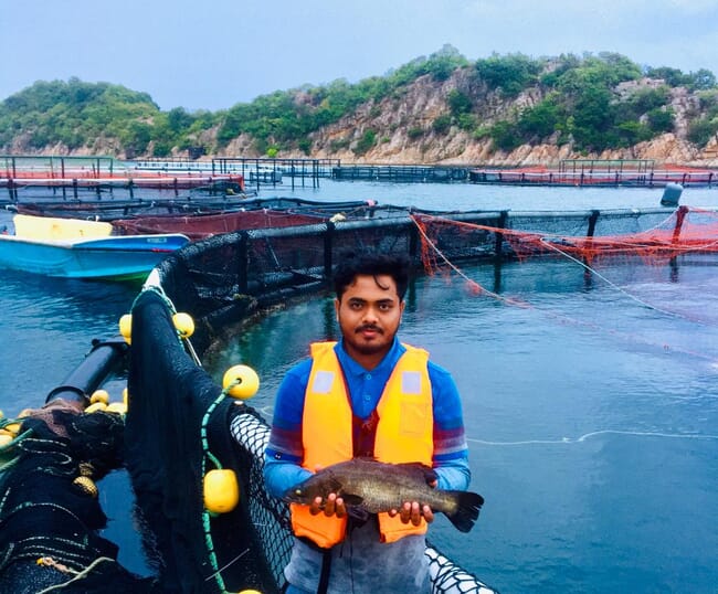 person holding a barramundi