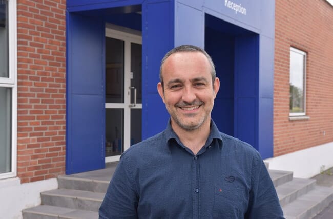 Portrait of a man standing infront of a company.