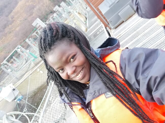 Woman standing near a sea cage