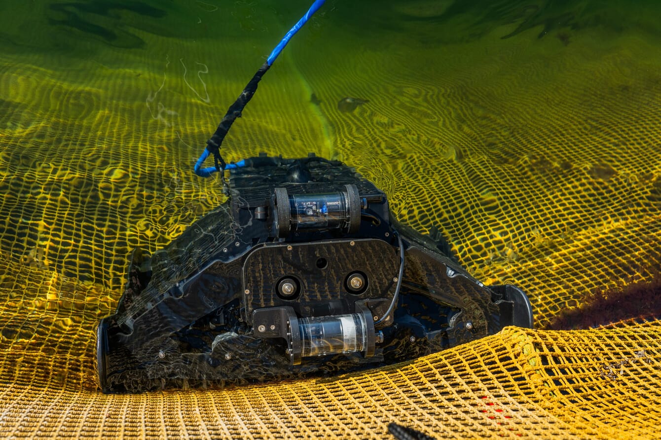 A robot cleaning a fish pen net.