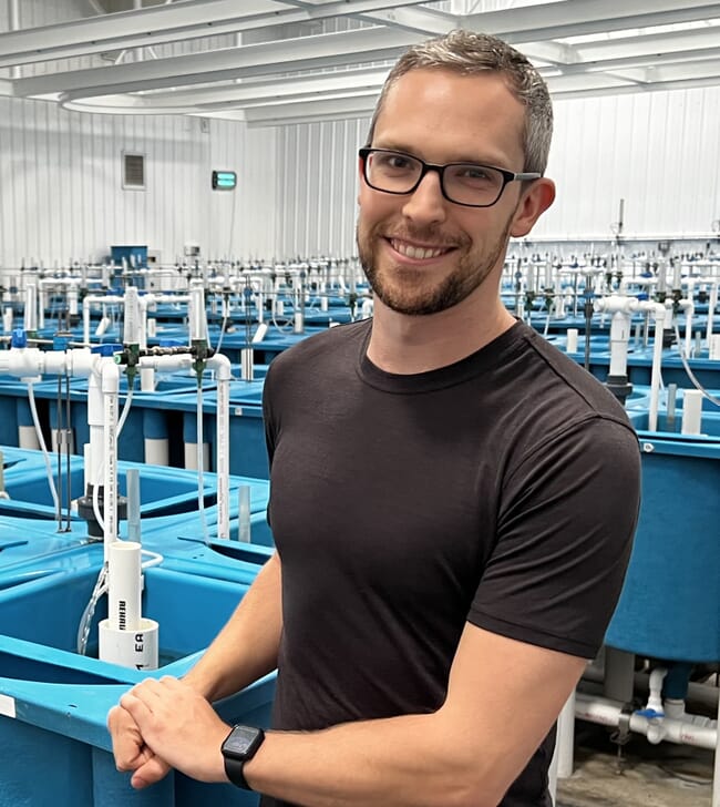 A man standing in a research centre.