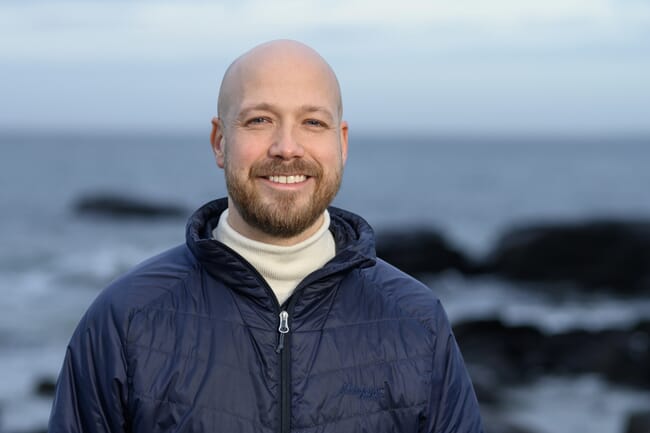 A man standing by the sea.