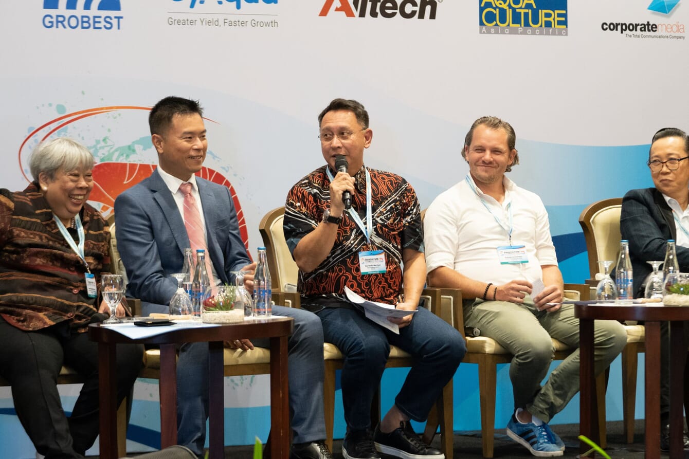 People on stage taking part in a panel discussion.
