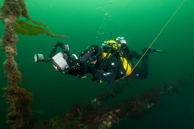 A technical diver with an underwater camera in a loch in Scotland.
