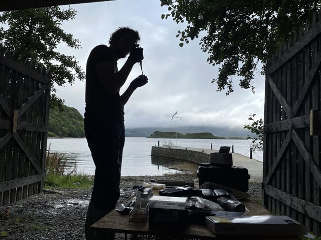The silhouette of a person carrying out a test on an oyster.