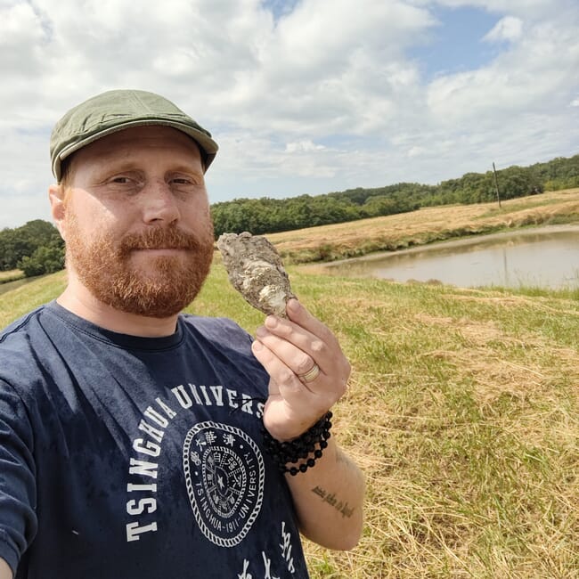 A man holding an oyster