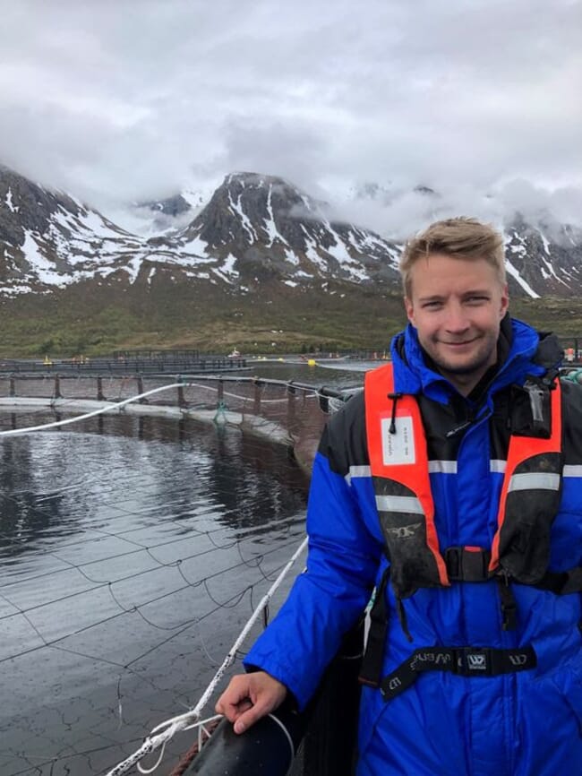 A man standing on a salmon cage.