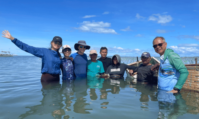A group of people in the sea.